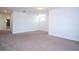 Spacious carpeted bedroom with a glimpse of an en-suite bathroom and a nearby window at 10209 Henbury St, Orlando, FL 32832