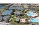 Aerial view of community pool, splash pad, tennis courts, basketball court, and covered picnic area with chairs at 10209 Henbury St, Orlando, FL 32832