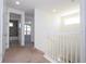 Upstairs hallway with carpet, white railings, and an open bathroom at 10209 Henbury St, Orlando, FL 32832