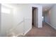 Upstairs hallway featuring carpet, white railings, and natural lighting at 10209 Henbury St, Orlando, FL 32832