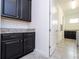 Stylish laundry area with dark cabinetry and granite countertops, blending functionality with modern design at 10209 Henbury St, Orlando, FL 32832