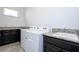 Well-equipped laundry room with modern washer, dryer, and granite countertop for efficient and easy laundry at 10209 Henbury St, Orlando, FL 32832