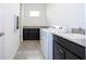 Functional laundry room with washer, dryer, sink, and granite countertops, for efficient chores at 10209 Henbury St, Orlando, FL 32832