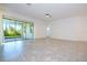 Spacious living room featuring tile floors, sliding glass doors, and neutral wall color at 10209 Henbury St, Orlando, FL 32832