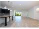 Bright living room with tile floors, modern lighting, and sliding glass doors to the backyard at 10209 Henbury St, Orlando, FL 32832