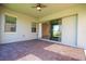 Covered patio featuring brick floors, ceiling fan, and sliding glass doors at 10209 Henbury St, Orlando, FL 32832