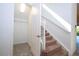 Carpeted staircase with white railing next to an open closet space with wire shelving in a well-lit home at 10209 Henbury St, Orlando, FL 32832