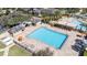 Aerial view of the community pool with a splash pad, lounge chairs, and shaded seating areas at 10209 Henbury St, Orlando, FL 32832