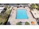 Aerial view of the expansive community pool with ample seating, umbrellas, and manicured landscaping at 10209 Henbury St, Orlando, FL 32832