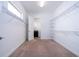 Large walk-in closet with carpet, shelving and a view of the laundry room, offering ample storage at 10209 Henbury St, Orlando, FL 32832