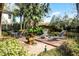 Backyard features a paver patio with lounge chairs, dining area, and lush tropical landscaping at 1203 Gatwick Loop, Lake Mary, FL 32746