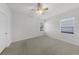 Carpeted bedroom with ceiling fan and two windows offering natural light at 1203 Gatwick Loop, Lake Mary, FL 32746
