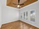Bedroom featuring a tray ceiling, wood floors and plantation shutters for natural light control at 1203 Gatwick Loop, Lake Mary, FL 32746