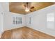 Bedroom with hardwood floors, tray ceiling, and abundant natural light through plantation shutters at 1203 Gatwick Loop, Lake Mary, FL 32746