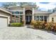 Charming home with manicured landscaping, paver driveway, and elegant front entrance at 1203 Gatwick Loop, Lake Mary, FL 32746