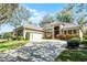 A beautifully landscaped home with a paver driveway and a neutral color palette at 1203 Gatwick Loop, Lake Mary, FL 32746