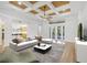 Bright living room featuring modern furnishings, coffered ceilings and sliding doors to the backyard at 1203 Gatwick Loop, Lake Mary, FL 32746