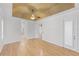Spacious primary bedroom with tray ceiling, hardwood floors, and an ensuite bathroom at 1203 Gatwick Loop, Lake Mary, FL 32746