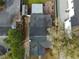 Aerial view of the home with a dark roof, surrounded by trees and neighboring houses at 125 E Grant St, Orlando, FL 32806