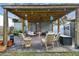 Backyard patio with a wooden pergola, seating, and a view of the green yard and shed at 125 E Grant St, Orlando, FL 32806