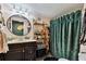 Detailed bathroom featuring stylish decor, gold fixtures, and a large mirror at 125 E Grant St, Orlando, FL 32806