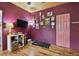 Stylish bedroom featuring hardwood floors, decor, and colorful pink accents at 125 E Grant St, Orlando, FL 32806