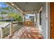 Stained wooden porch with a hanging swing and black railings at 125 E Grant St, Orlando, FL 32806