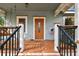 Close up of the front porch with stained wood and a light blue exterior at 125 E Grant St, Orlando, FL 32806