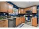 An open kitchen with stainless steel appliances, granite countertops, and blue walls at 125 E Grant St, Orlando, FL 32806