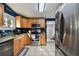 An open kitchen with stainless steel appliances, granite countertops, and blue walls at 125 E Grant St, Orlando, FL 32806