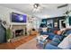 Inviting living room features a brick fireplace, hardwood floors, and a comfortable blue sectional at 125 E Grant St, Orlando, FL 32806