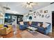 Open living room with hardwood floors, statement decor, and a stylish blue sectional at 125 E Grant St, Orlando, FL 32806