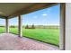 Covered brick patio looks out onto a well-maintained backyard and beautiful green space beyond the fence at 16207 Point Rock Dr, Winter Garden, FL 34787