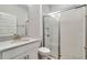 Modern bathroom with a glass enclosed shower, a wood floor, and a white vanity at 16207 Point Rock Dr, Winter Garden, FL 34787