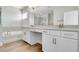 Bathroom featuring double sinks, granite countertops, wooden tile floors, and modern fixtures at 16207 Point Rock Dr, Winter Garden, FL 34787