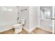 Bright bathroom features a shower-tub combo with white subway tile surround and wood look tile flooring at 16207 Point Rock Dr, Winter Garden, FL 34787