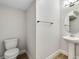 Modern powder room features pedestal sink, toilet, and updated fixtures for a clean and functional space at 16207 Point Rock Dr, Winter Garden, FL 34787