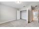 Bright bedroom featuring neutral colors, carpet, and a closet with a door in the background at 16207 Point Rock Dr, Winter Garden, FL 34787