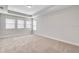 Spacious bedroom features plush carpet, tray ceilings, and natural light from multiple windows at 16207 Point Rock Dr, Winter Garden, FL 34787