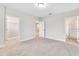 Bedroom featuring neutral carpeting, ample natural light and an ensuite bath at 16207 Point Rock Dr, Winter Garden, FL 34787