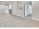 Bonus room area with neutral carpeting, and multiple access points to other rooms at 16207 Point Rock Dr, Winter Garden, FL 34787