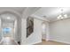 Inviting home foyer featuring arched entryways, a staircase, chandelier, and light-colored tile flooring at 16207 Point Rock Dr, Winter Garden, FL 34787