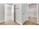 Hallway with wood-look tile flooring and access to the bedroom and walk-in closet at 16207 Point Rock Dr, Winter Garden, FL 34787
