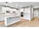 Modern kitchen with white cabinets, center island, stainless steel appliances, and tile flooring at 16207 Point Rock Dr, Winter Garden, FL 34787