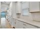 Stylish kitchen with white cabinets, quartz countertops, subway tile backsplash, and stainless steel appliances at 16207 Point Rock Dr, Winter Garden, FL 34787