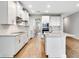 Bright kitchen features white cabinets, stainless steel appliances and a kitchen island for added counter space at 16207 Point Rock Dr, Winter Garden, FL 34787