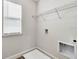 Clean laundry room with wire shelving, hookups, and a window for natural light at 16207 Point Rock Dr, Winter Garden, FL 34787