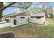 View of the front of the home, featuring a quaint gated courtyard and neutral color scheme at 169 Fallwood St, Fern Park, FL 32730