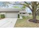 Charming single-story home with a well-maintained lawn, mature trees, and attached garage at 169 Fallwood St, Fern Park, FL 32730