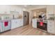 Bright kitchen featuring stainless steel appliances, white cabinetry, and a view to the living room at 169 Fallwood St, Fern Park, FL 32730